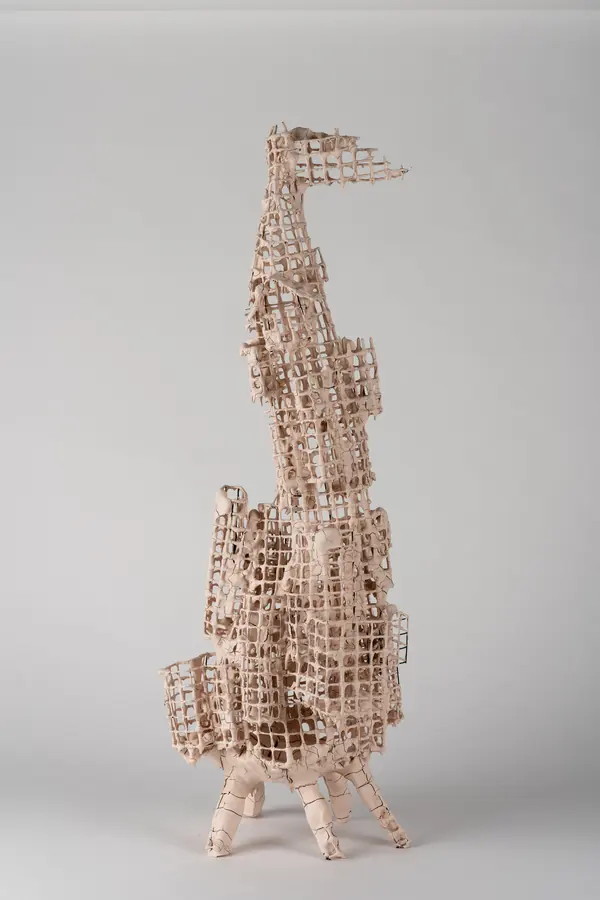Tall ceramic grid sculpture photographed on a white background
