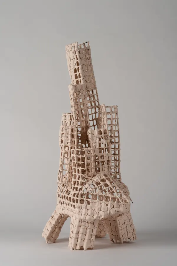 Ceramic grid tower sculpture on a white background